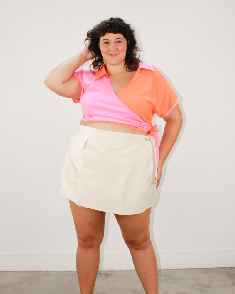 Front of a model wearing a size L Bowler Colorblocked Wrap Top in Juicy Fruit by Lovefool. | dia_product_style_image_id:274337